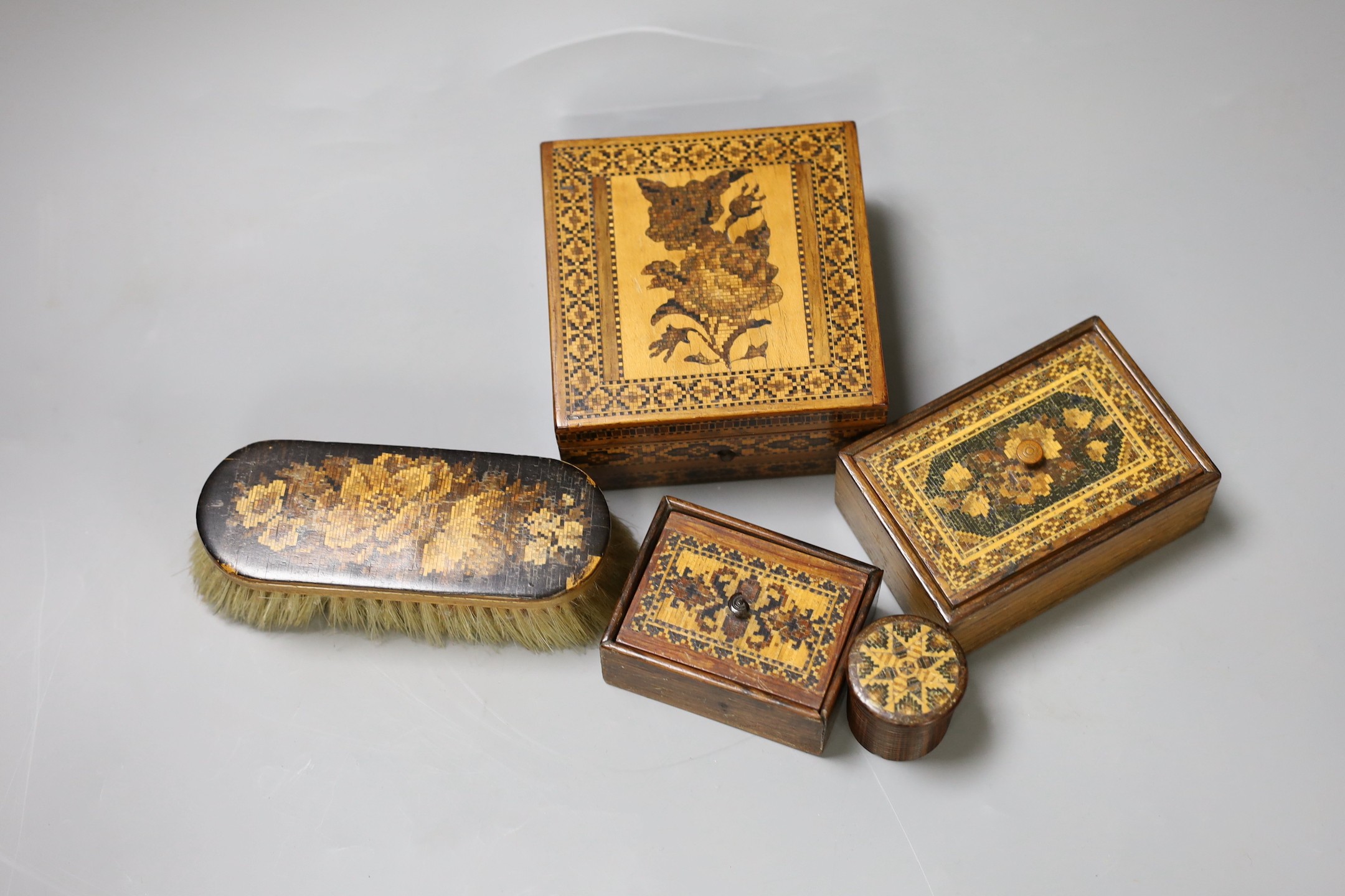 Victorian Tunbridgeware, to include three boxes and lids, a pot with twisted lid, and a brush (5)